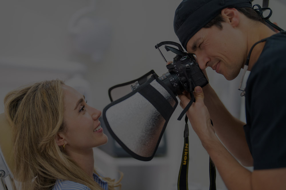 Doctor Íñigo Gastaminza fotografiando sonrisa de paciente
